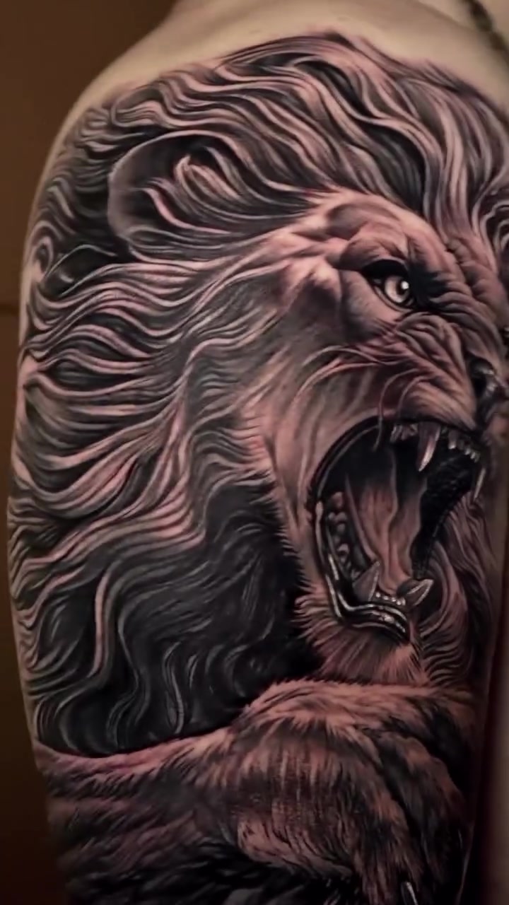 Detailed black and grey surreal lion tattoo by Marcus Arroyo
